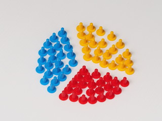 Three groups split up illustrated by coloured plastic board game hats in various colours, Melbourne...