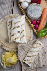 burrito on parchment with vegetables