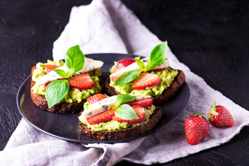 Fresh toast with strawberry on black plate