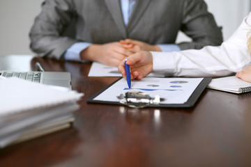 Close up  of unknown  business people at meeting discussing financial results