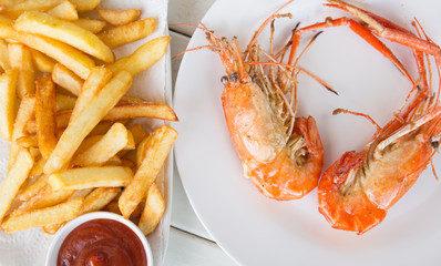 Fried shrimp with salt on dish and french fried