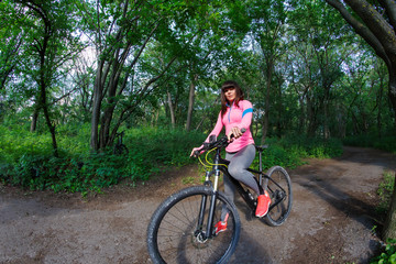 Fototapeta na wymiar cyclist woman riding a bicycle in park