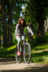 cyclist woman riding a bicycle in park