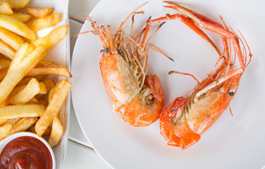 Fried shrimp with salt on dish and french fried