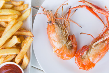 Fried shrimp with salt on dish and french fried