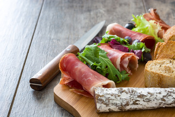 Spanish serrano ham, olives and sausages
on wood