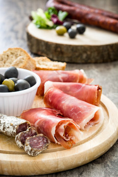 Spanish serrano ham, olives and sausages
on wood