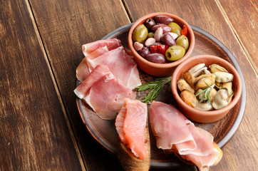 Tapas of salmon, mussels, jamon and olives