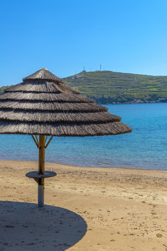 Sunshade umbrellas on the beach during a sunny summer day in Myk