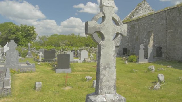 Celtic cross in an Irish graveyard, County Clare, Ireland. Flat video profile.