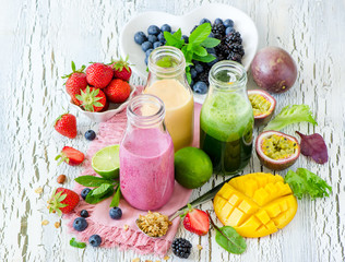 Berry and fruits smoothie in bottles, healthy summer detox drink