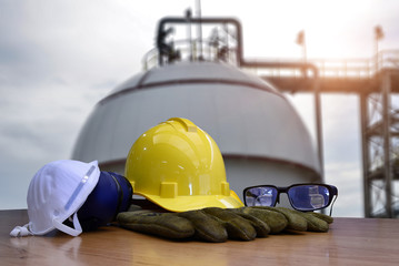 Set of safety work wear on Storage Tank refinery background , image construction concept.