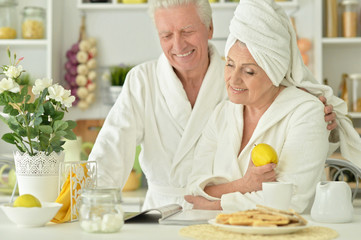 mature couple in a bathrobe at kitchen