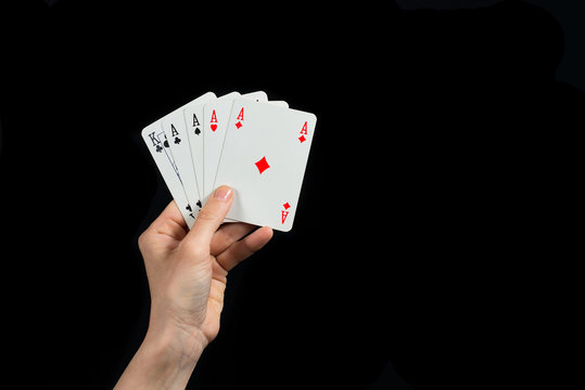 Poker of aces in hand isolated on black background