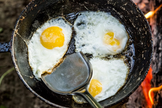 shovel removes roasting egg from the pan