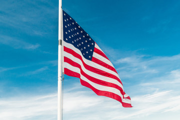 American flag against bright blue sky