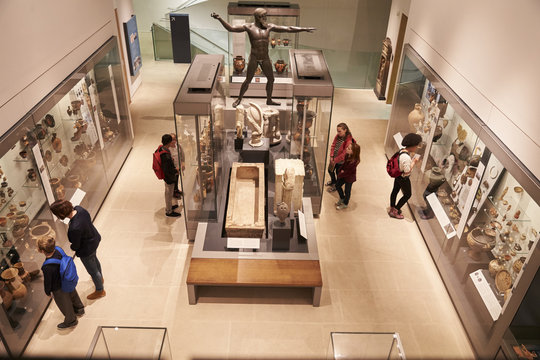 Overhead View Of Busy Museum Interior With Visitors