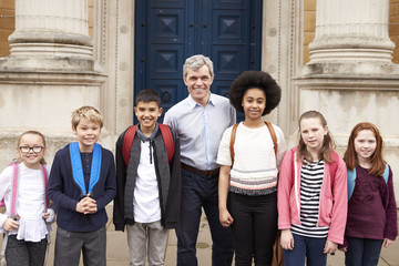 Portrait Of Teacher With Class Standing Outside Museum