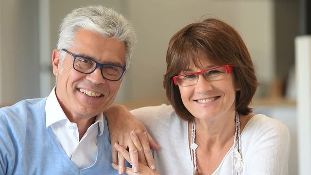 Cheerful senior couple with eyeglasses