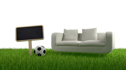 Sofa, ball and blank chalkboard in grass