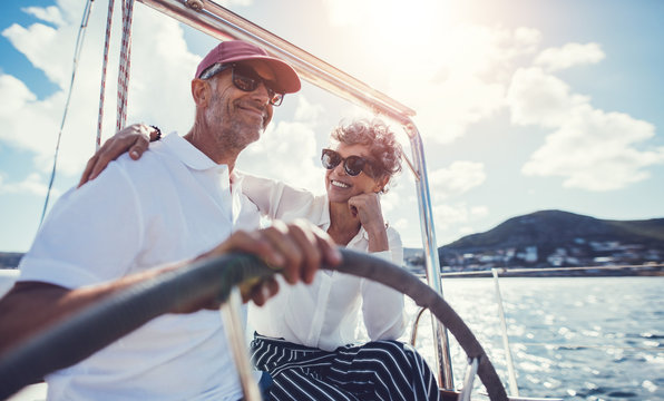 Smiling mature couple on yacht