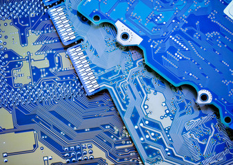 Circuit board close-up picture. Blue industrial background.