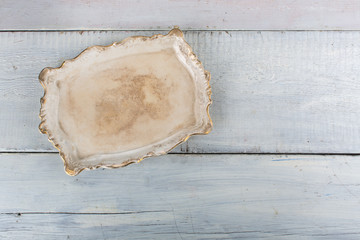 Vintage porcelain tray on a white wood