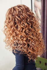 close-up of curly blond hair in barber beauty salon
