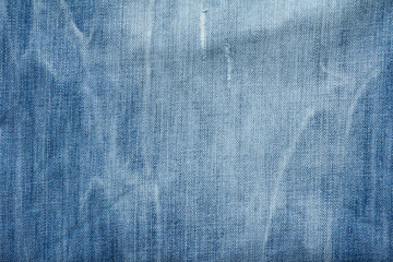 Closed up of blue creased denim jeans texture