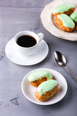 Breakfast with mint eclairs and cup of coffee