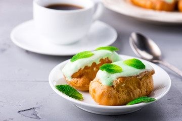 Breakfast with mint eclairs and cup of coffee