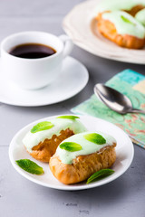 Breakfast with mint eclairs and cup of coffee