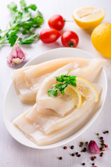 Raw squid and ingredients on the white plate