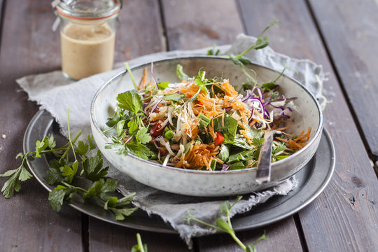 Rainbow salad with spinach leaves, peas, carrots, mung bean sprouts, quinoa, parsly, pea sprouts, red cabbage