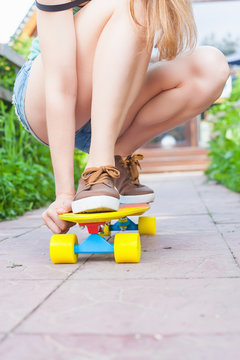 Close-up skateboarder riding by skateboard outdoor. Skatebord at city, street