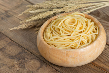 Boiled spaghetti in wood bowl.