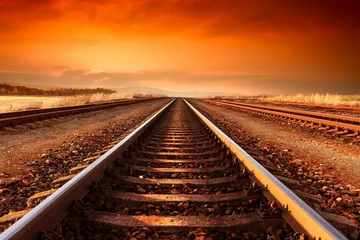 Papier Peint photo Chemin de fer La voie ferrée va à l& 39 horizon dans le majestueux coucher de soleil.