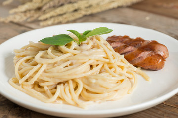 Spaghetti cream sauce chopped mushroom with sausage.
