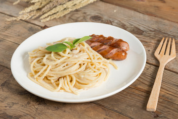Spaghetti cream sauce chopped mushroom with sausage.