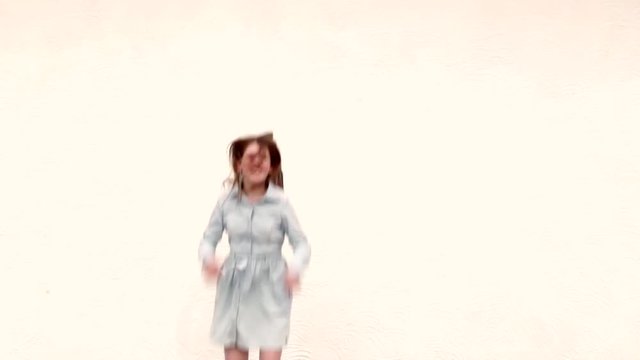 Young girl jumping on the white background in slow motion