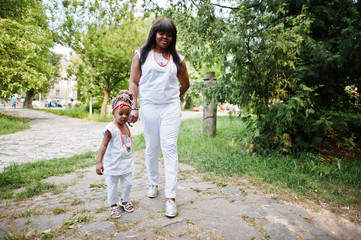 Fototapeta premium African american mother with daughter walking at park
