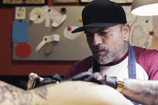 Tattoo artist tattooing a woman