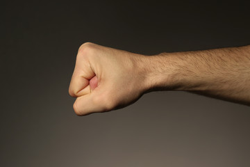 Male fist on grey background