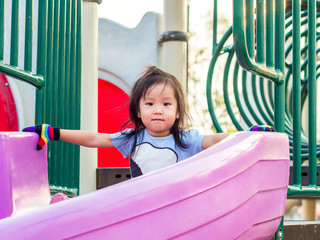 Fototapeta na wymiar Happy kid, asian baby child playing on playground