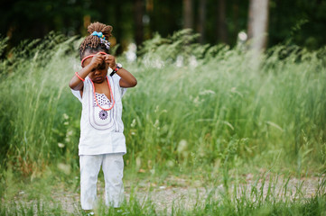 African baby girl walking at park