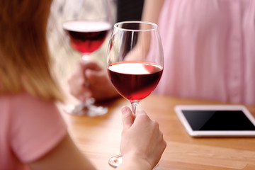Young women drinking wine in cafe