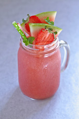 Watermelon and strawberry smoothie in a jar
