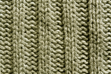 Abstract beige knitting texture close-up.