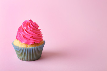 Birthday cupcake on light pink background