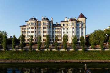 Fototapeta na wymiar new modern house on the embankment with green grass and trees in Kazan Russia.